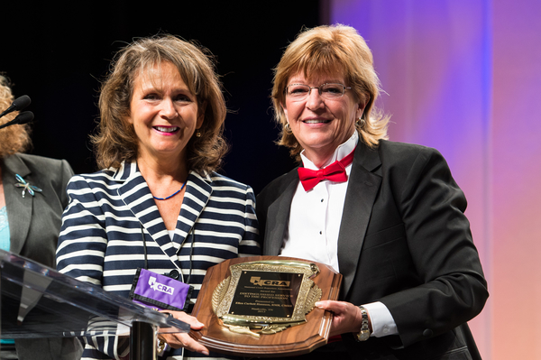 Ellie Corbett Hannum (left) receives NCRA's 2013 Distinguished Service Award from NCRA Immediate Past President Tami Keenan (right).