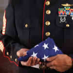 Uniformed soldier holding a flag