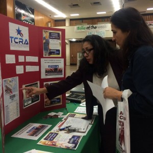 A court reporter explains the court reporting keyboard to a school counselor