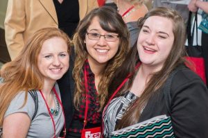 Three smiling female students at the NCRA Convention & Expo
