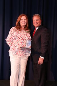 Karla Martin poses with Mayor Mark Mitchell after receiving her award