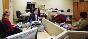 From L to R: Cheryl Hansberry transcribes as Mike Hansberry interviews Fred Becchetti, while Michelle Houston provides CART.