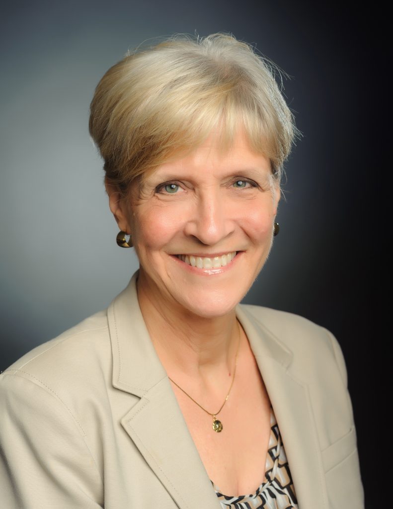 Headshot of an NCRF Major Gifts donor: a woman in profressional attire poses in front of a studio background