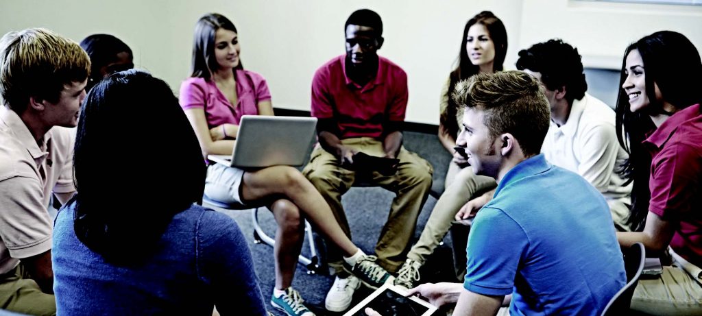 A group of students sit in a circle