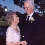 Photo of an NCRF Major Gifts donor: A husband and wife in formal dress -- as if for a wedding -- gaze at each other