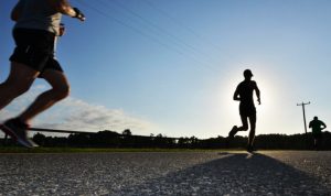 Back view of runners against the sun, so the runners are in shadow