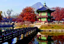 Scene of a Japanese temple surrounded by mountains, fall foliage, and water, with a bridge