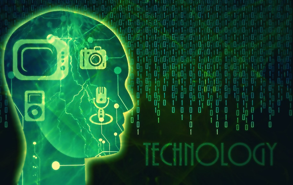 Outline of a human head in profile with a TV, radio, and iPod within the head; the head is facing towards lines of computer code with the word "Technology" at the bottom. The entire image is in green and black.