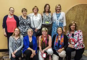 The captioning team for the 2018 HLAA Conference: back row: Megan Stumm, Angie Sundell, Lisa Richardson, Lori Morrow, and Whitney Riley; Front row: Kristi Artzen, Lisa Johnston, Deanna Baker, Lori Yeager Stavropoulos, and Sharon Vivian. (Not pictured: Jayne Carriker)