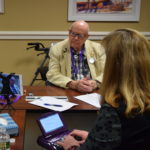 Cindy Davis, an official court reporter from Annapolis, Md., transcribes volunteer Martha Wooldridge’s interview with U.S. Veteran John Kenny, who served in World War II, during the recent NCRF and Library of Congress Veterans History Project event held at the Ginger Cove Retirement Community in Annapolis.