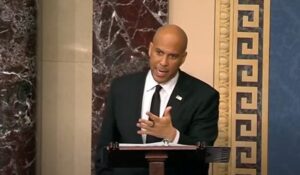 Senator Cory Booker standing at a podium speaking