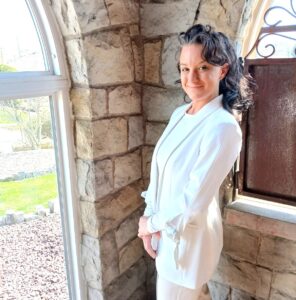 Woman standing in front of a window and smiling