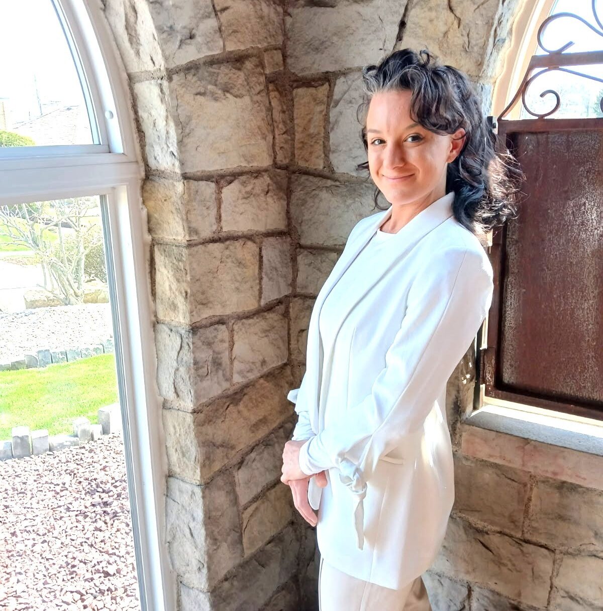 Woman standing in front of a window and smiling