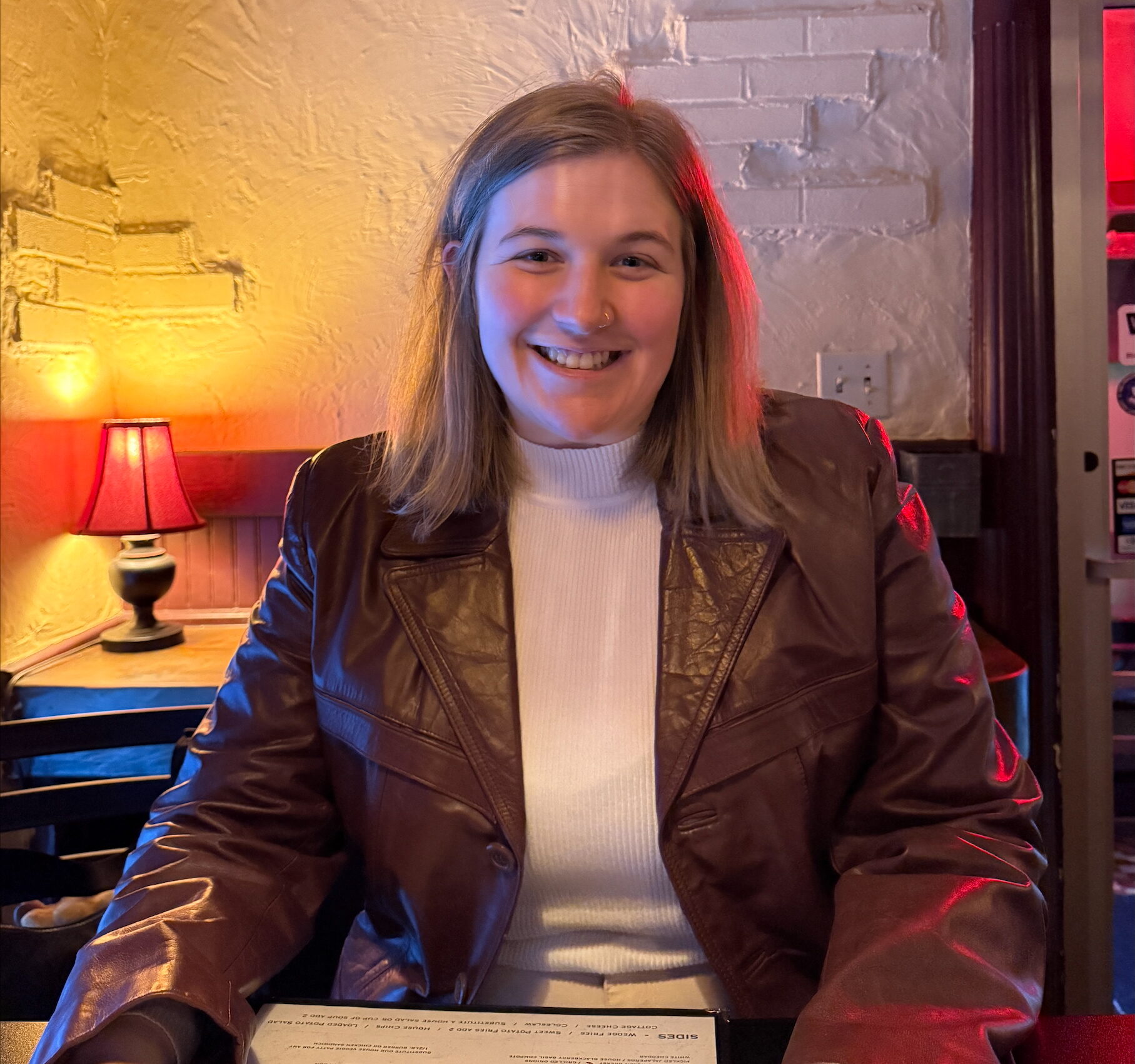 Woman sitting in a restaurant smiling