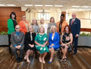Groupf of professional people seated and standing posing for a picture