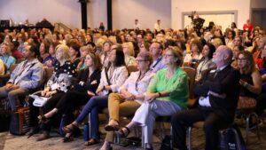 Crowd seated watching the stage
