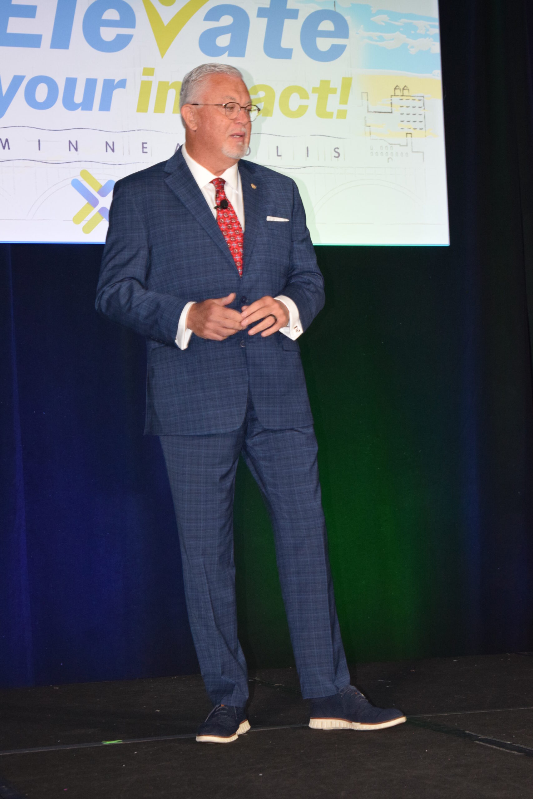A man on a stage giving a speech