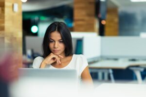 Woman in an office looking at laptop