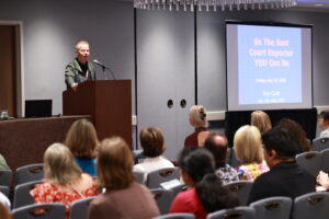 A man making a speech to an audience
