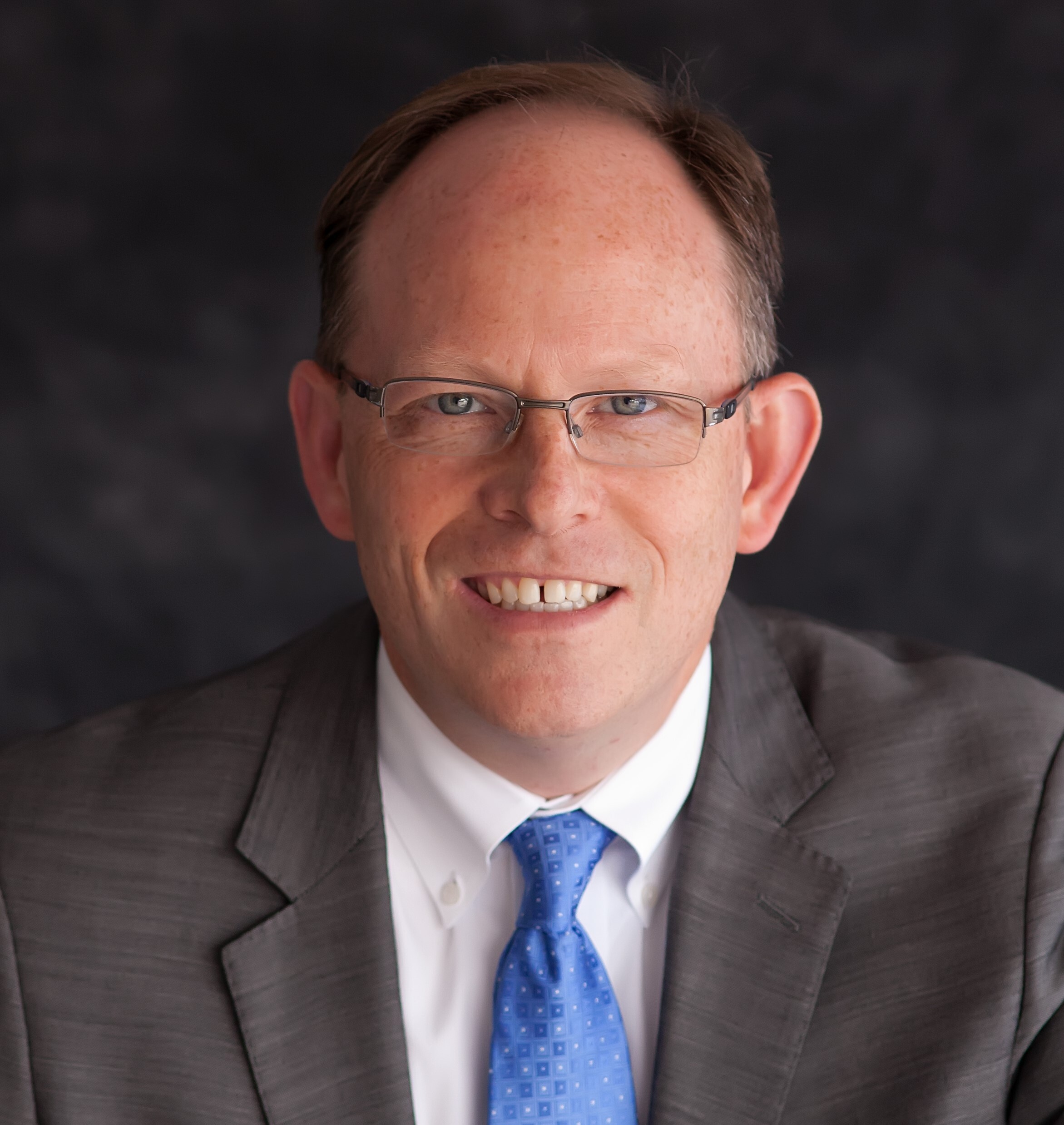 Headshot of a man in a tie