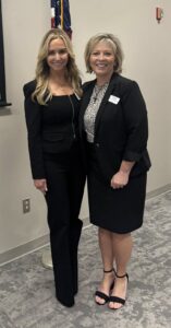 Two women standing in a hallway