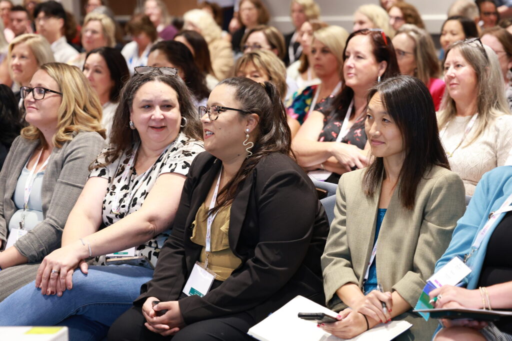 People sitting in an audience chatting
