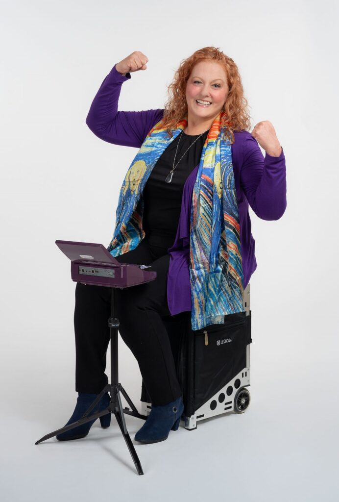A person sitting behind a steno machine and cheering
