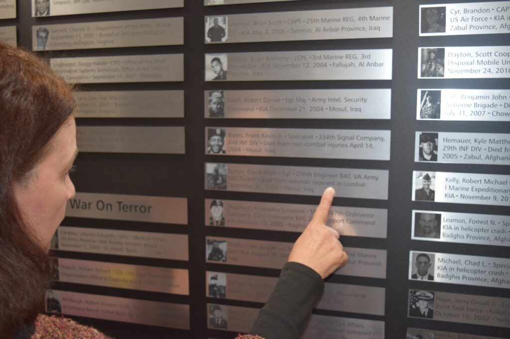 Woman pointing at a plaque