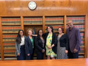A group of people posing in a law library