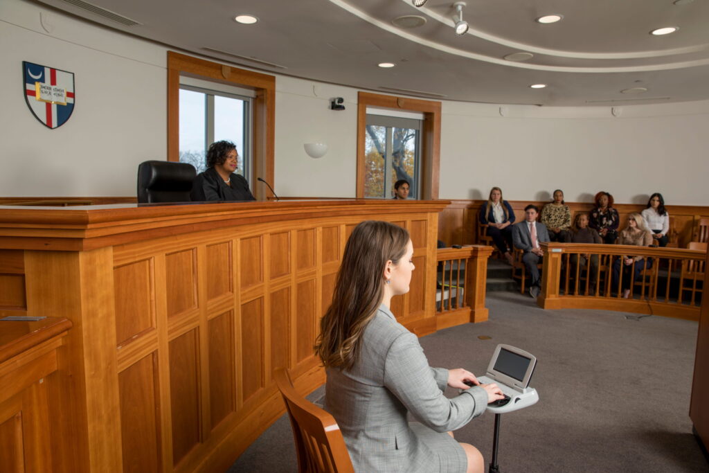 a stenographer sitting in a courtroom