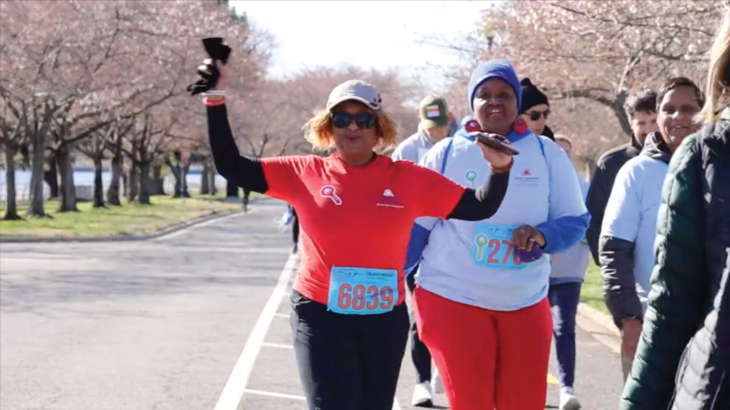 Woman running a race and cheering