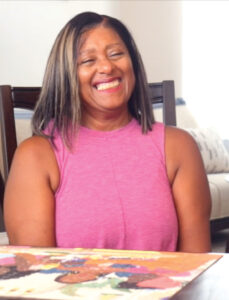Woman sitting in a chair smiling at the camera