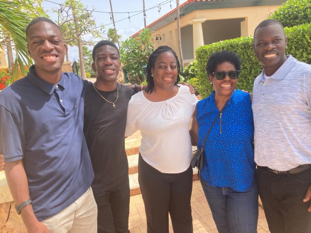 A family linking arms and posing for the camera