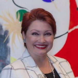 A woman in a suit smiling in a professional headshot