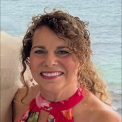 Woman at the beach smiling at the camera