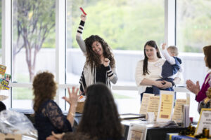 A woman celebrating after winning a raffle prize