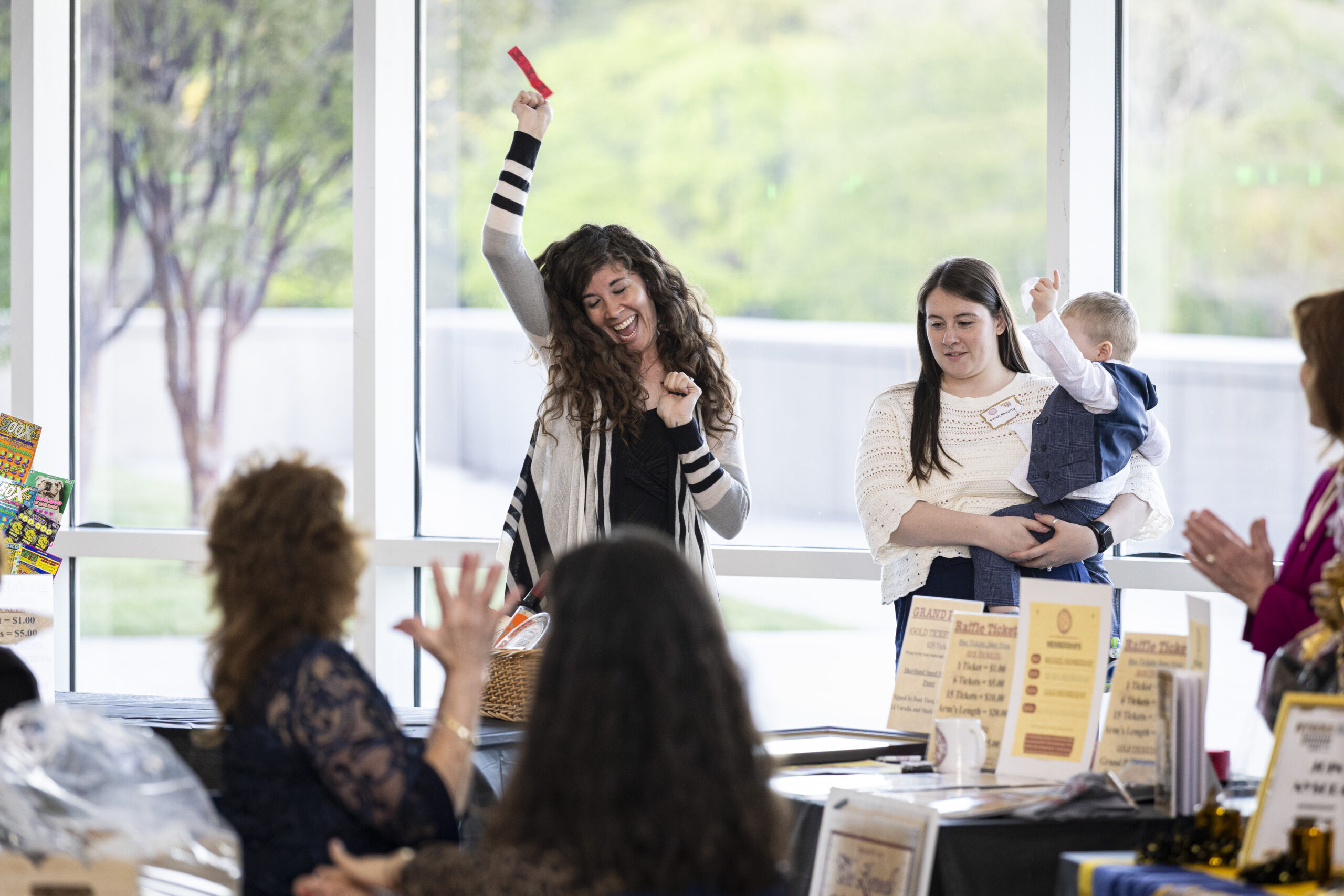 A woman celebrating after winning a raffle prize