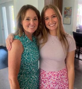 Two women arm and arm posing for the camera