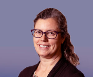 Headshot of a woman in glasses smiling