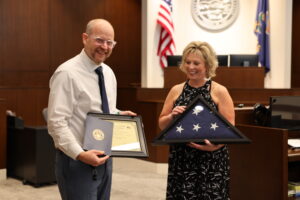 Cindy Isaacsen presenting a flag to Judge Robert J. Wonnell